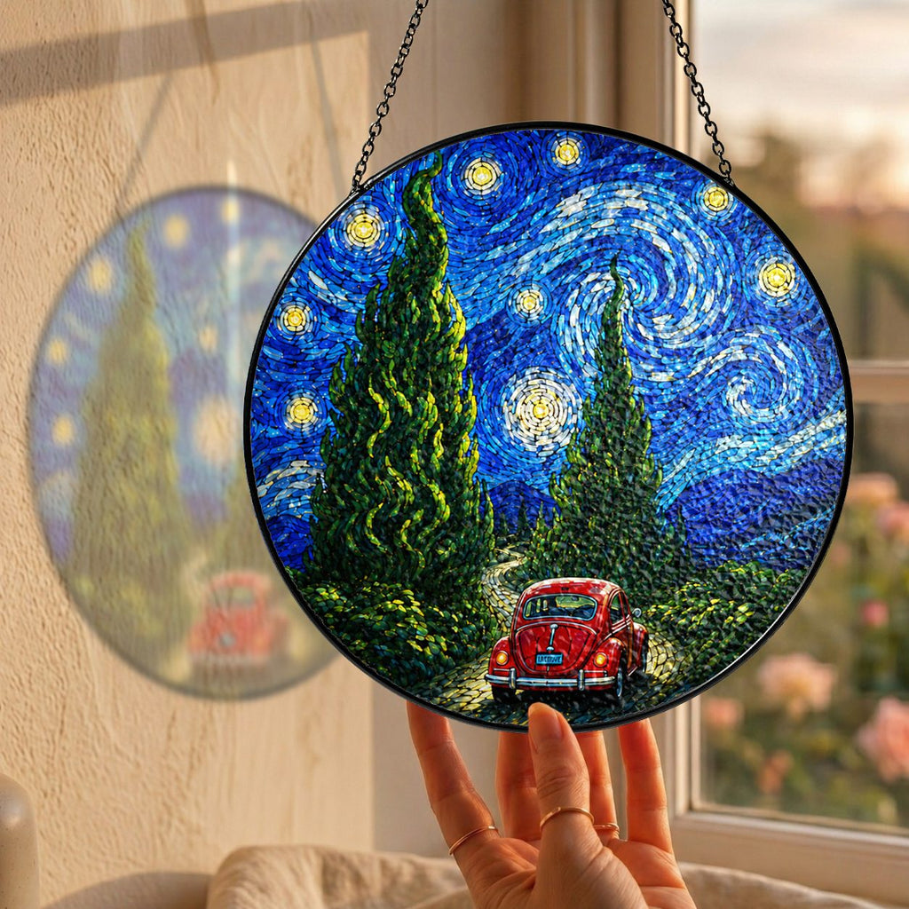 Hand holding the red car suncatcher at a window