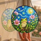 Hand holding the frog blossom suncatcher at a window