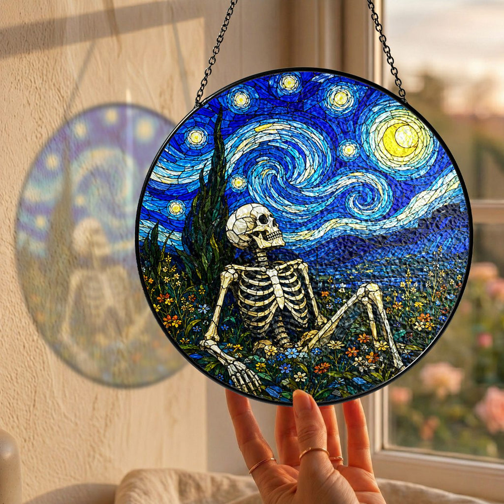 Hand holding the skeleton suncatcher at a window