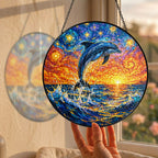 Hand holding the dolphin suncatcher at a window