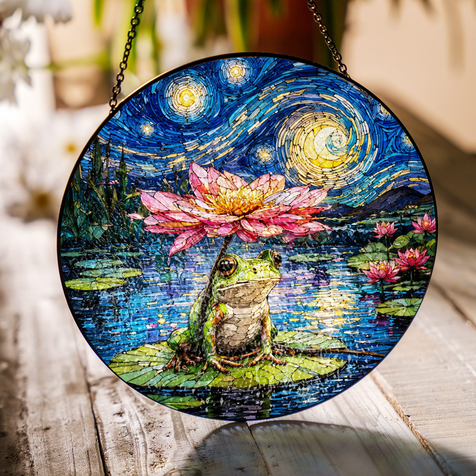 Frog lotus umbrella suncatcher on a wooden table in sunlight