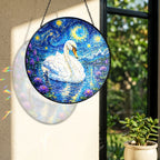 Rainbow light cast by the swan stained glass suncatcher