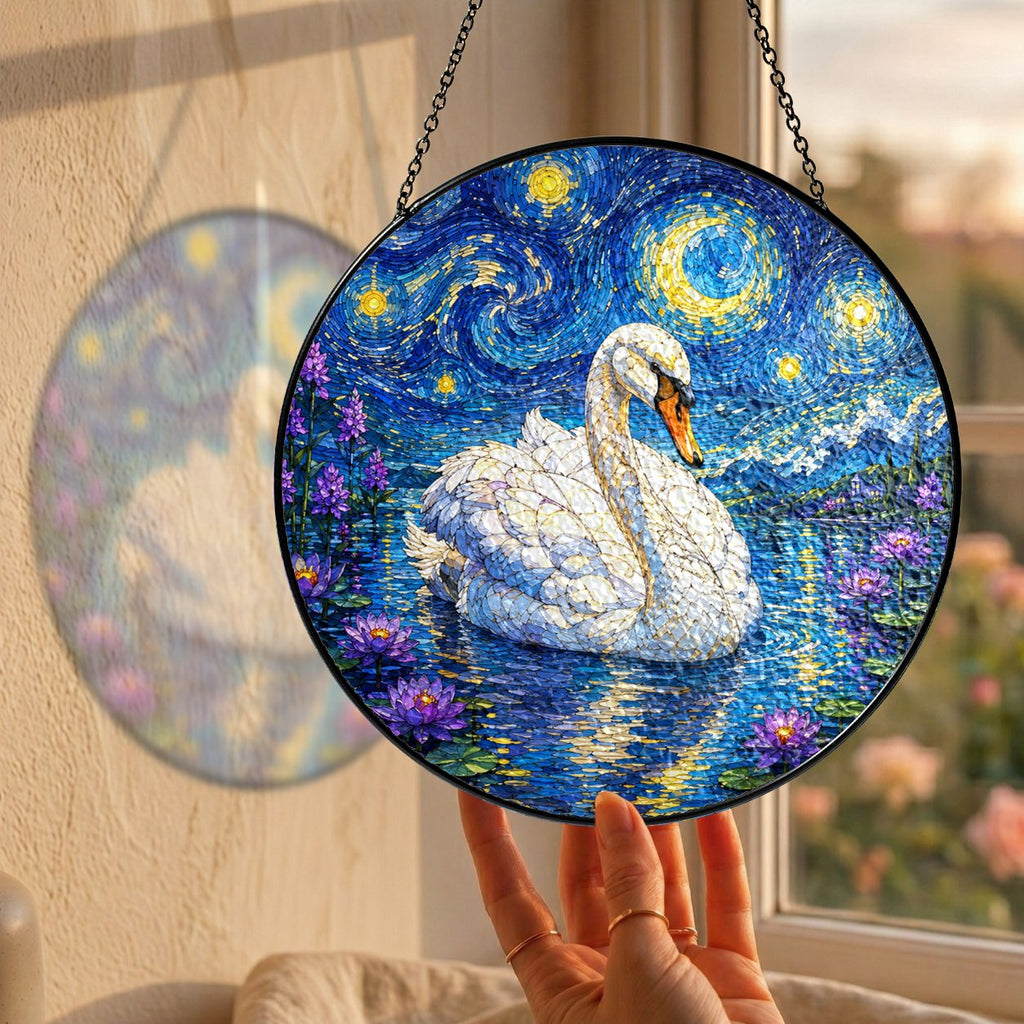 Hand holding the swan suncatcher at a window