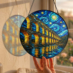 Hand holding the aqueduct suncatcher at a window