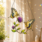 Stained glass style suncatcher with two yellow swallowtail butterflies and purple clover flowers, hanging in a sunlit window with rainbow light