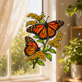 Monarch butterflies and golden goldenrod holographic acrylic suncatcher in a sunlit window