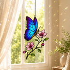 Blue morpho butterfly suncatcher hanging in a bright window