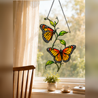 Twin monarch butterflies suncatcher by a breakfast window