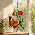 Orange butterflies and red blossom holographic acrylic suncatcher in a sunlit window