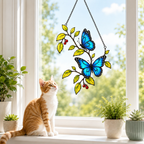 Cat admiring blue morpho butterflies berry branch suncatcher on a windowsill