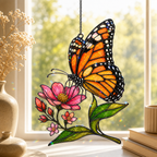 Monarch butterfly and pink wildflower holographic acrylic suncatcher in a sunlit window