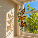 Monarch butterfly trio suncatcher casting shadows on a wall