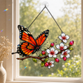 Monarch butterfly cherry blossom suncatcher in a sunlit window