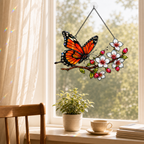 Monarch butterfly cherry blossom suncatcher in a dining room window