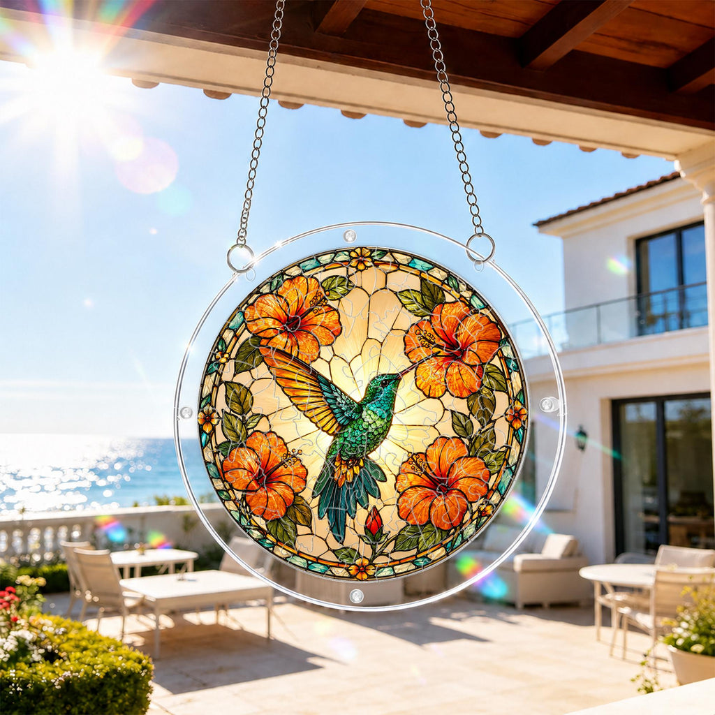 Round hibiscus hummingbird acrylic puzzle suncatcher hanging beside a bright balcony window.