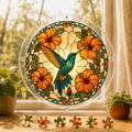 Round Sunburst Hibiscus Hummingbird acrylic puzzle suncatcher hanging in a sunny window with colorful loose puzzle pieces below.