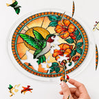 Hand placing a puzzle piece into the Tangerine Bloom Hummingbird acrylic puzzle suncatcher.
