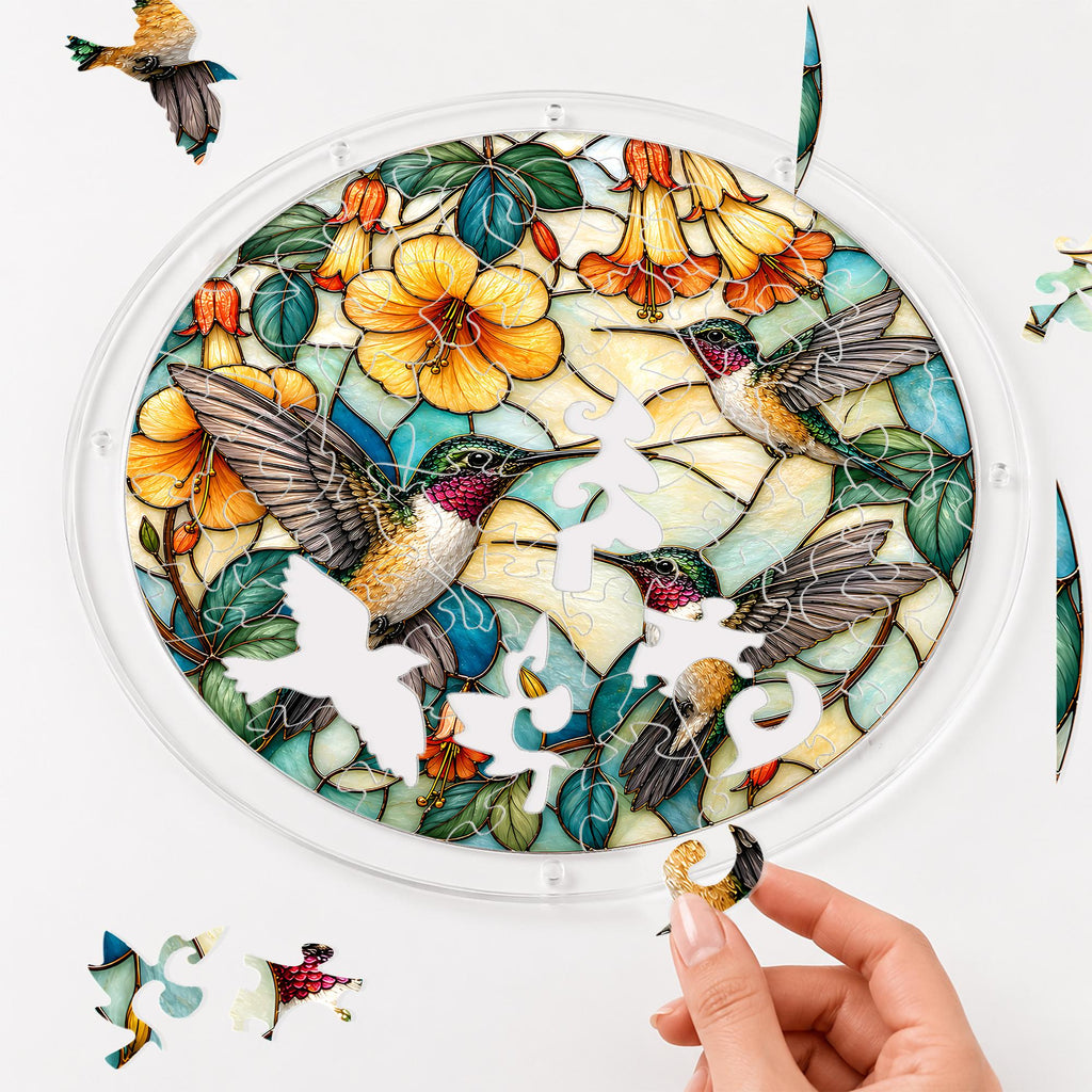Hand assembling a three hummingbirds yellow flower acrylic puzzle suncatcher