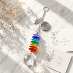Personalized Tree of Life memorial crystal suncatcher displayed on marble surface with sympathy card, rainbow crystals, and soft sunlight