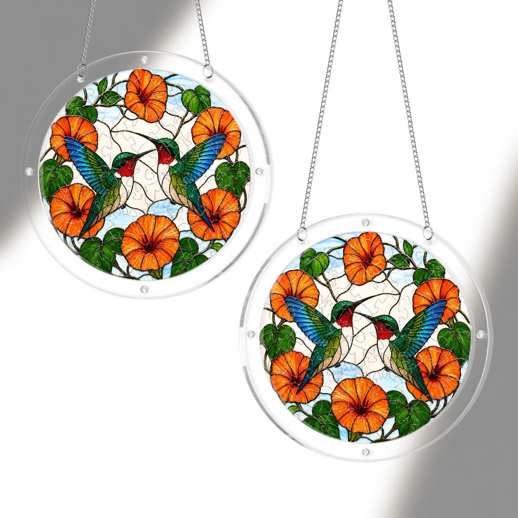 Two orange flower hummingbird acrylic puzzle suncatchers hanging together to show size options