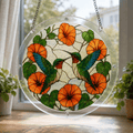 Two hummingbirds orange flower acrylic puzzle suncatcher hanging by a bright window with clear frame and metal chain