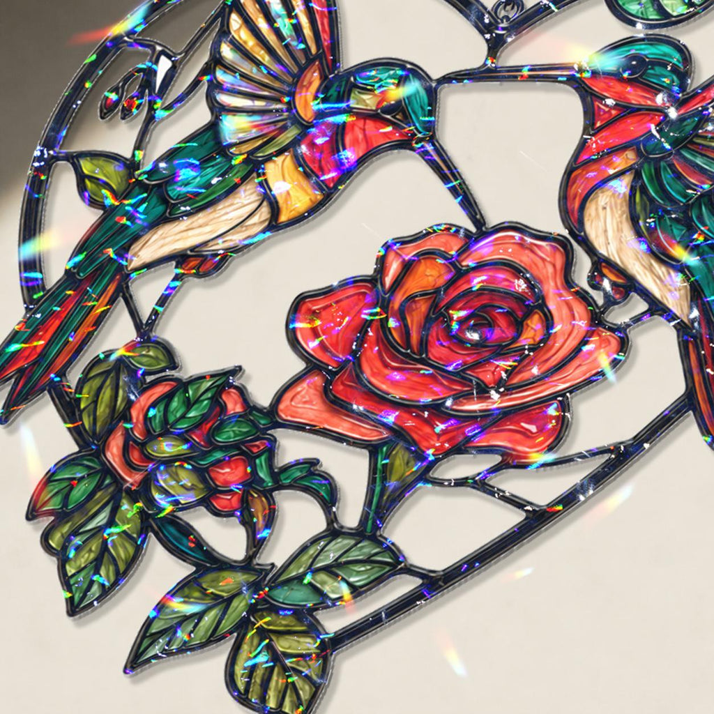 Close-up of two hummingbirds and red rose heart holographic acrylic suncatcher showing broken glass rainbow finish.

