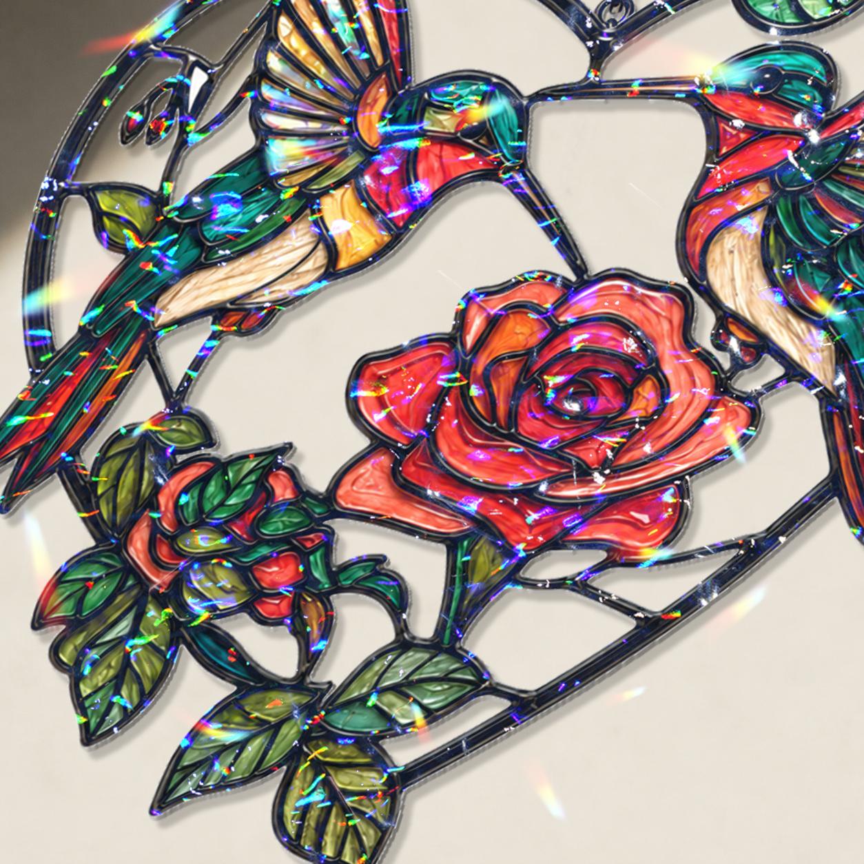 Close-up of two hummingbirds and red rose heart holographic acrylic suncatcher showing broken glass rainbow finish.
