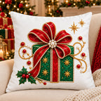 Embroidered Christmas pillow cover with an emerald gift box under a big ruby bow stitched on white canvas