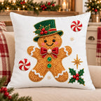 Embroidered Christmas pillow cover with a gingerbread man in an emerald top hat stitched on white canvas