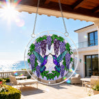 Round hummingbird and wisteria acrylic puzzle suncatcher hanging in a cozy wooden window corner with soft natural light.