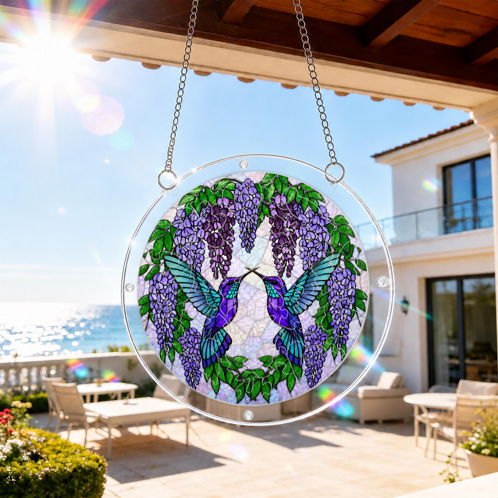 Round hummingbird and wisteria acrylic puzzle suncatcher hanging in a cozy wooden window corner with soft natural light.