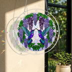 Round acrylic hummingbird puzzle suncatcher hanging on a window with purple wisteria flowers and two hummingbirds.